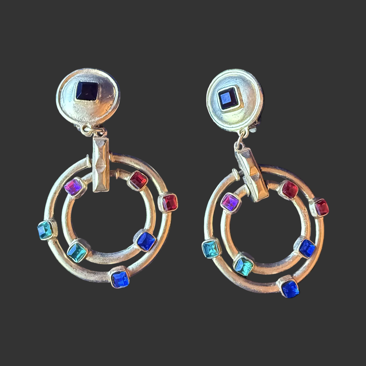Vintage 1980’s brushed gold-tone statement clip on earrings with jewel-toned square-cut rhinestones.