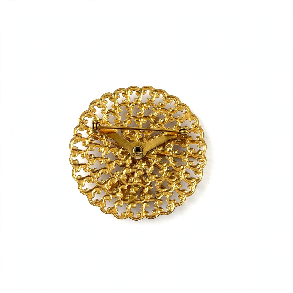 Circa 1950’s-1960’s gold-tone filagree brooch with vibrant magenta & pink navette rhinestones