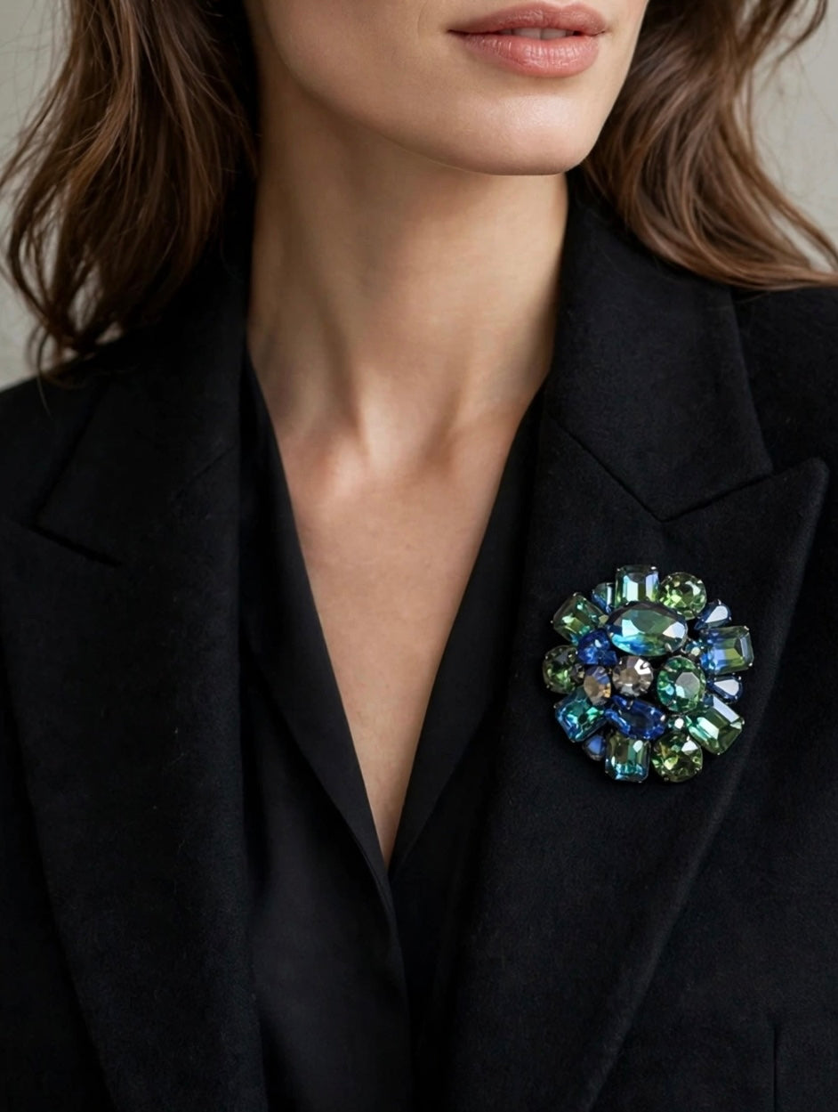Signed Kramer 1950’s dimensional, domed, round cluster brooch with peacock colored faceted glass stones. Wow factor Sparkle!